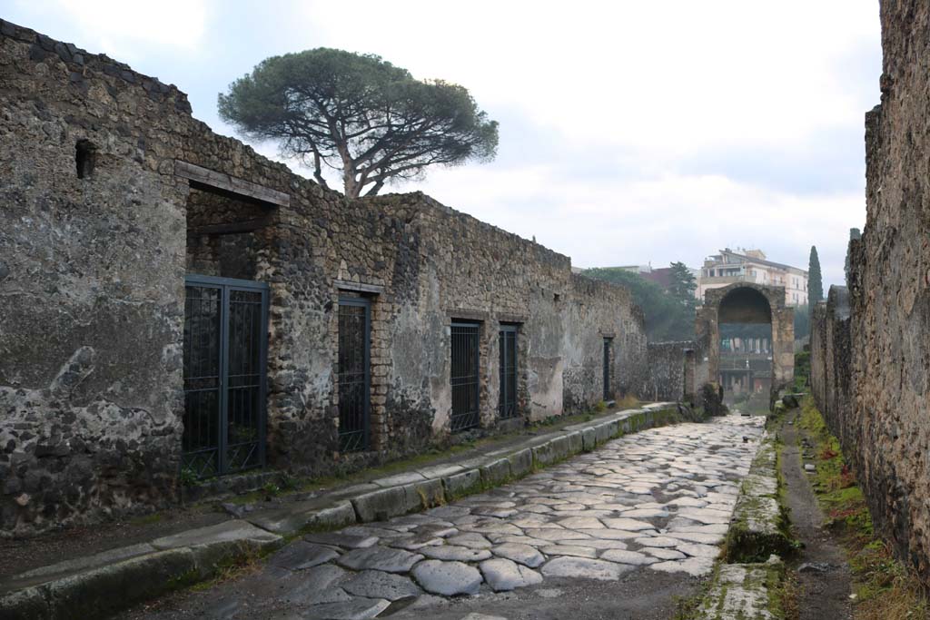 Via di Nocera, east side, Pompeii, December 2018. 
Looking south from near II.8.5, on left, towards Porta di Nocera, with I.20, on right. Photo courtesy of Aude Durand.
