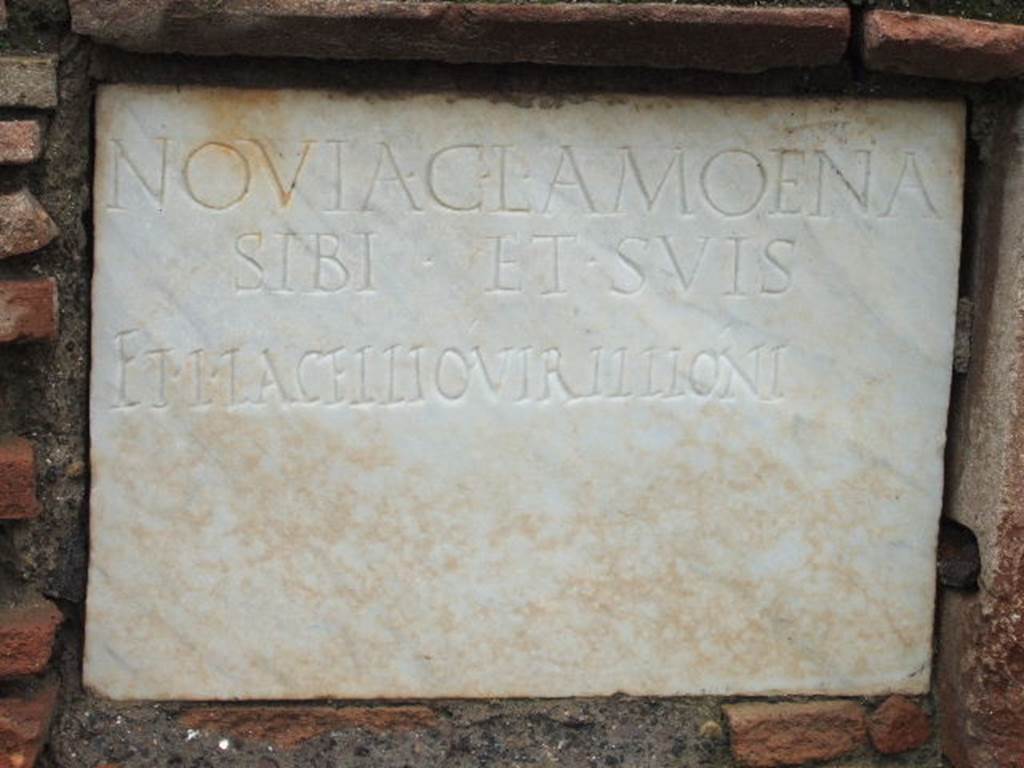FPNE Pompeii. December 2005. Marble plaque in centre of brick pilaster in tomb.
The inscription reads 
NOVIA C. L. AMOENA 
SIBI ET SVIS 
ET L. IACELLIO VIRILLIONI.

D’Ambrosio and De Caro expand this to:
Novia C(ai) l(iberta) Amoena 
sibi et suis 
et L(ucio) Iacellio Virillioni

See D’Ambrosio A. and De Caro S., 1988. Römische Gräberstraßen. München: C.H.Beck. p. 208.