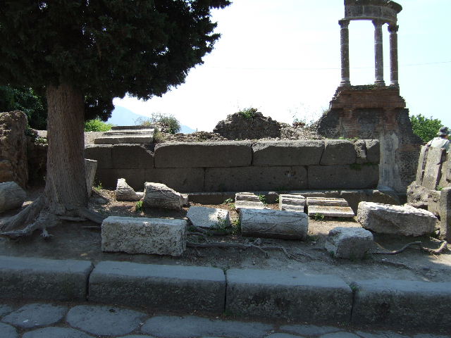HGW03 Pompeii. December 2006. Tomb of M. Porcius. Remaining boundary stone of tomb.  
The inscription reads

M   PORCI
M  F  EX  DEC
DECRET  IN
FRONTEM
PED  XXV
IN  AGRVM
PED  XXV

According to Epigraphik-Datenbank Clauss/Slaby (See www.manfredclauss.de) this reads

M(arci) Porci
M(arci) f(ilii) ex dec(urionum)
decret(o) in
frontem
ped(es) XXV
in agrum
ped(es) XXV      [CIL X 997]

According to Cooley this translates as 

Of Marcus Porcius, son of Marcus, by decree of the town councillors, 25 feet wide, 25 feet deep.

See Cooley, A. and M.G.L., 2004. Pompeii : A Sourcebook. London : Routledge. (p. 21, B12).