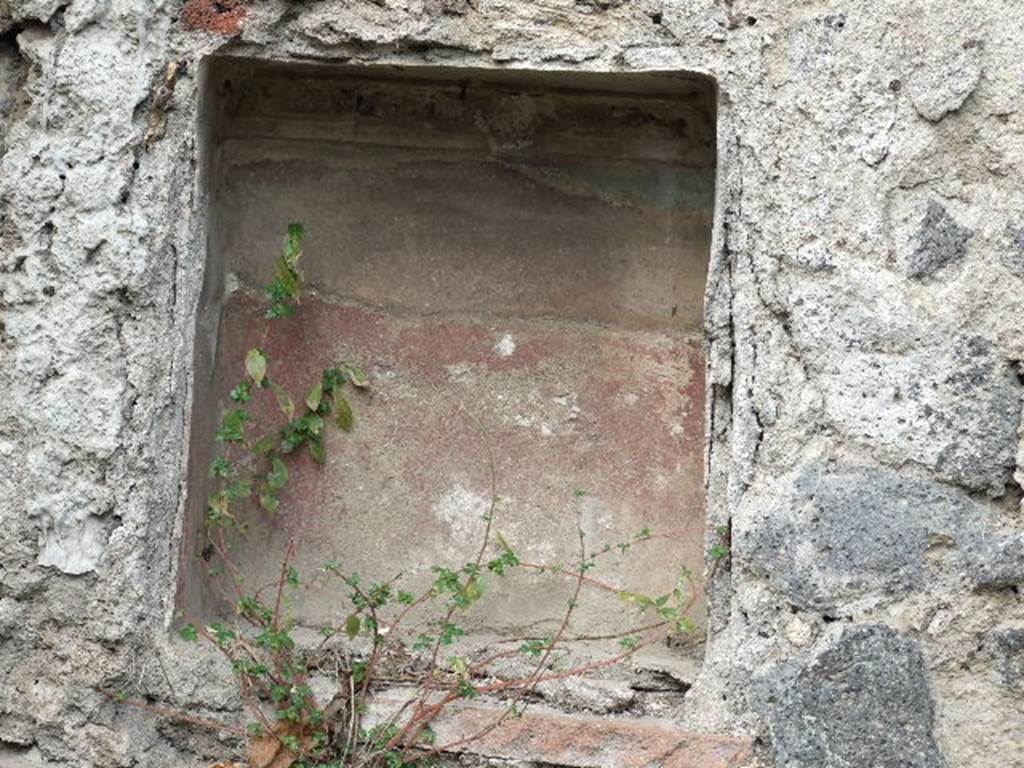 I.2.10 Pompeii. December 2006. Niche in North wall of garden.
According to Boyce, this had a ledge formed by a tile projecting on the level of its floor: the inside walls were red, the stucco ornaments red, white and blue.
See Boyce G. K., 1937. Corpus of the Lararia of Pompeii. Rome: MAAR 14. (p.22, Pl.1,1)
See Jashemski, W. F., 1993. The Gardens of Pompeii, Volume II: Appendices. New York: Caratzas. (p.22)
See Pappalardo, U., 2001. La Descrizione di Pompei per Giuseppe Fiorelli (1875). Napoli: Massa Editore. (p.35)
See Giacobello, F., 2008. Larari Pompeiani: Iconografia e culto dei Lari in ambito domestico. Milano: LED Edizioni. (p. 252)