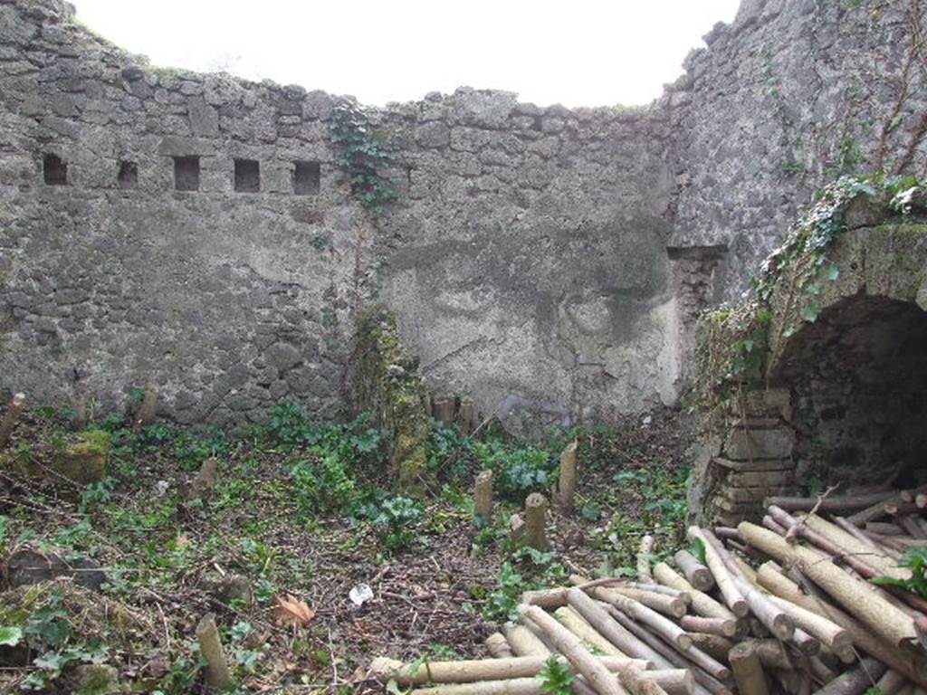 I.2.10 Pompeii. September 2010. Remains of summer biclinium, built against the north wall of the peristyle garden area. Below the north couch was a recess providing storage space. Photo courtesy of Drew Baker.