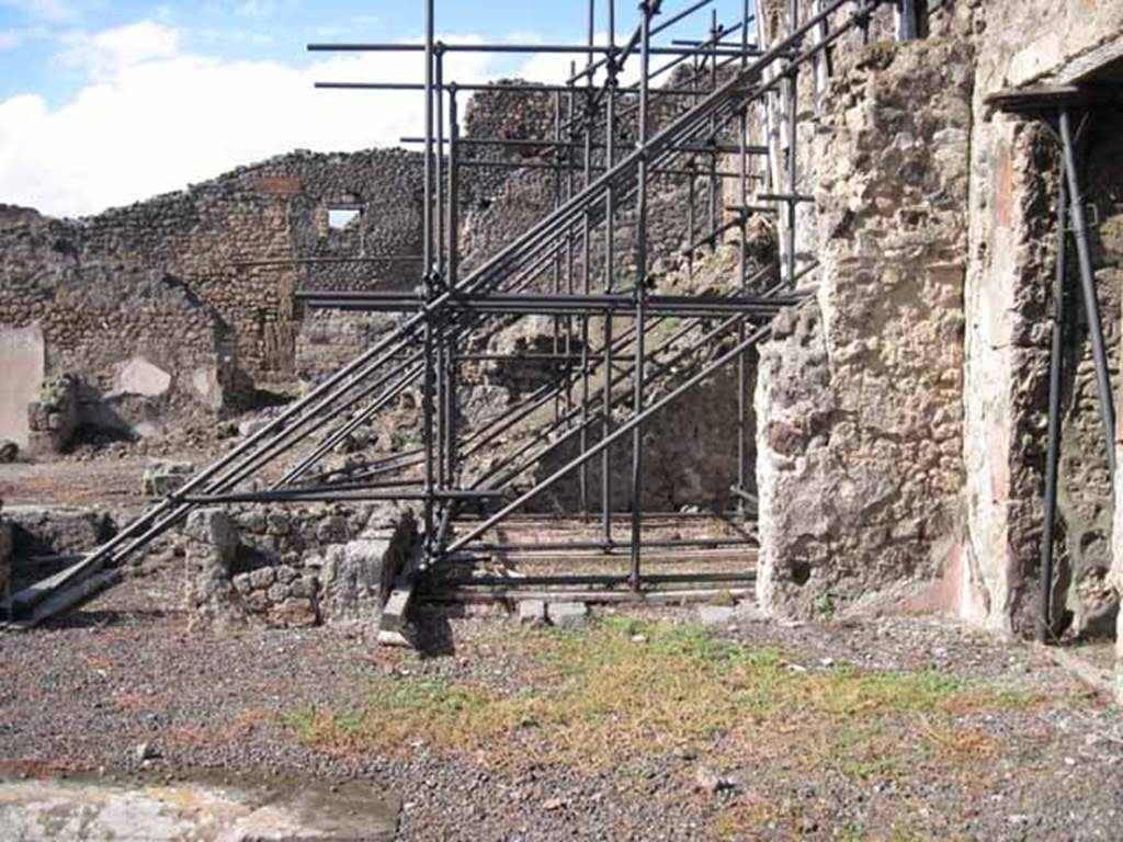 I.2.10 Pompeii. September 2010. Remains of north wall of atrium (north-east side), with doorway to rear of house, on right. Looking north towards I.2.11/12/13/14. Photo courtesy of Drew Baker.