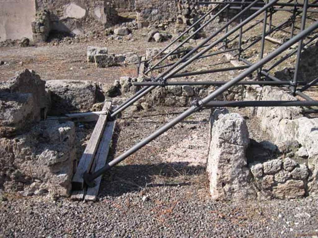 I.2.10 Pompeii. September 2010. Looking north into doorway of remains of cubiculum, in north-west corner of atrium. At the rear is I.2.11/12/13/14. Photo courtesy of Drew Baker.