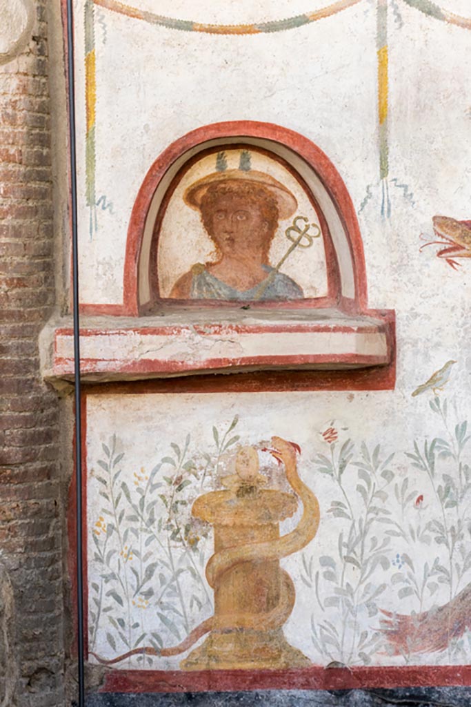 I.6.2 Pompeii. October 2023.
Detail from south end of lararium on west wall. Photo courtesy of Johannes Eber.