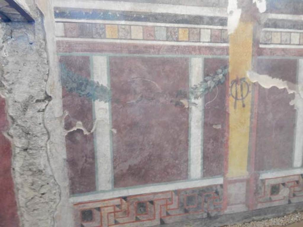 I.6.2 Pompeii. May 2016. South end of west wall, near doorway to oecus, on left.
Photo courtesy of Buzz Ferebee.