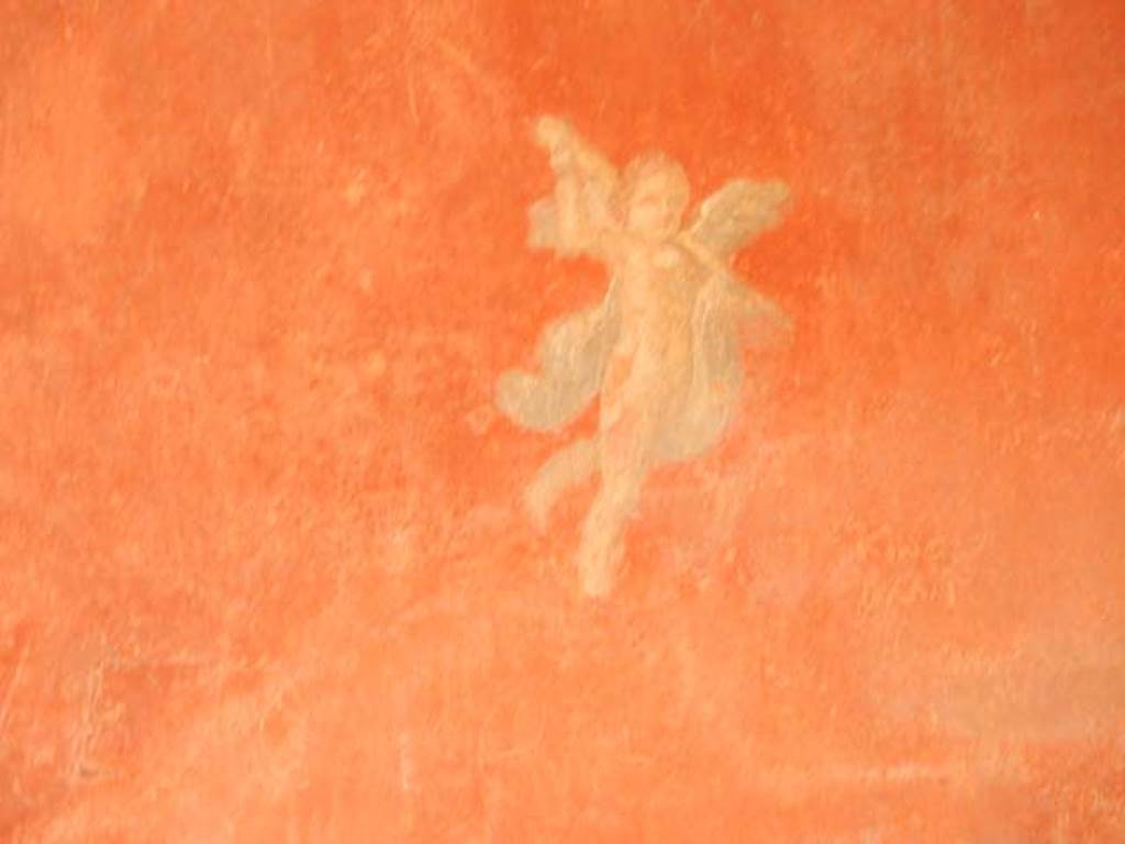I.6.7 Pompeii. May 2016. Detail of painted flying cupid from south end of east wall. Photo courtesy of Buzz Ferebee.