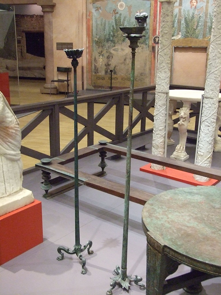 I.7.1 Pompeii. Bronze candelabrum (on right) with Ammon lamp soldered to top.
SAP 3244 (Candelabrum) and 3244a (Lamp).
Photographed at “A Day in Pompeii” exhibition at Melbourne Museum. September 2009.