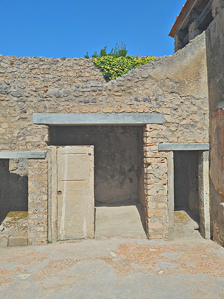 I.7.19 Pompeii. September 2024.
Doorways to rooms on north side of atrium. Photo courtesy of Giuseppe Ciaramella.