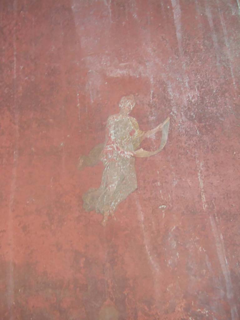 I.10.4 Pompeii. May 2006.
Room 18, west wall on south side of doorway to peristyle, painting of floating Muse with roll of paper.