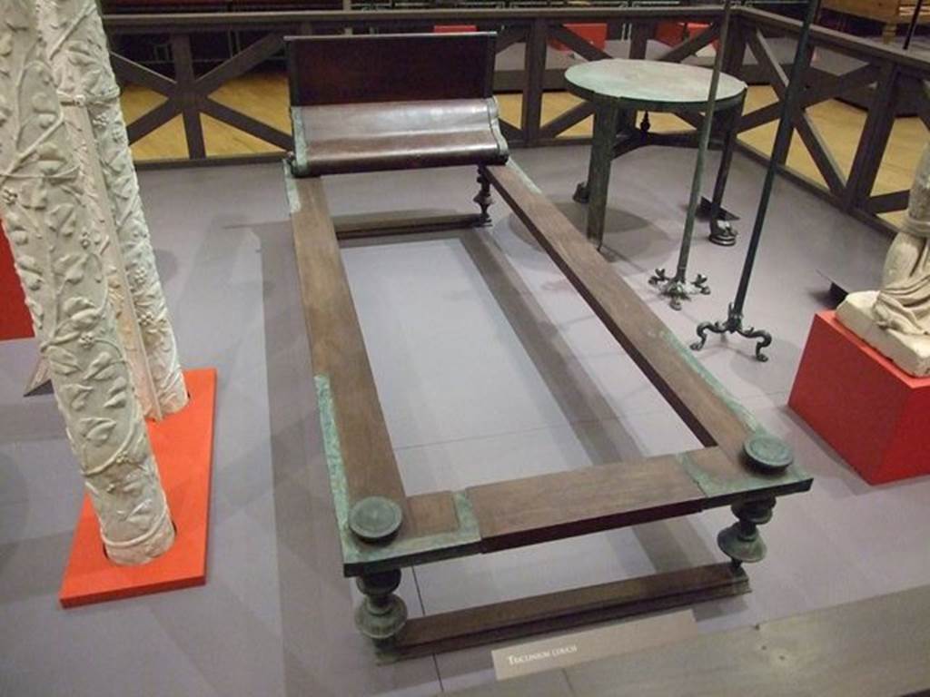 I.10.4 Pompeii. Reconstructed wood and bronze triclinium bed. SAP 4270a.
Photographed at “A Day in Pompeii” exhibition at Melbourne Museum. September 2009. The original was found in Room 8, the tablinum, on 18th August 1928.
