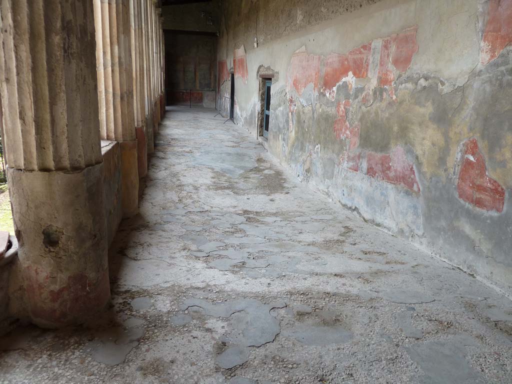 I.10.4 Pompeii. May 2010. Peristyle, looking south along west portico, with dip for Sarno canal underneath.
