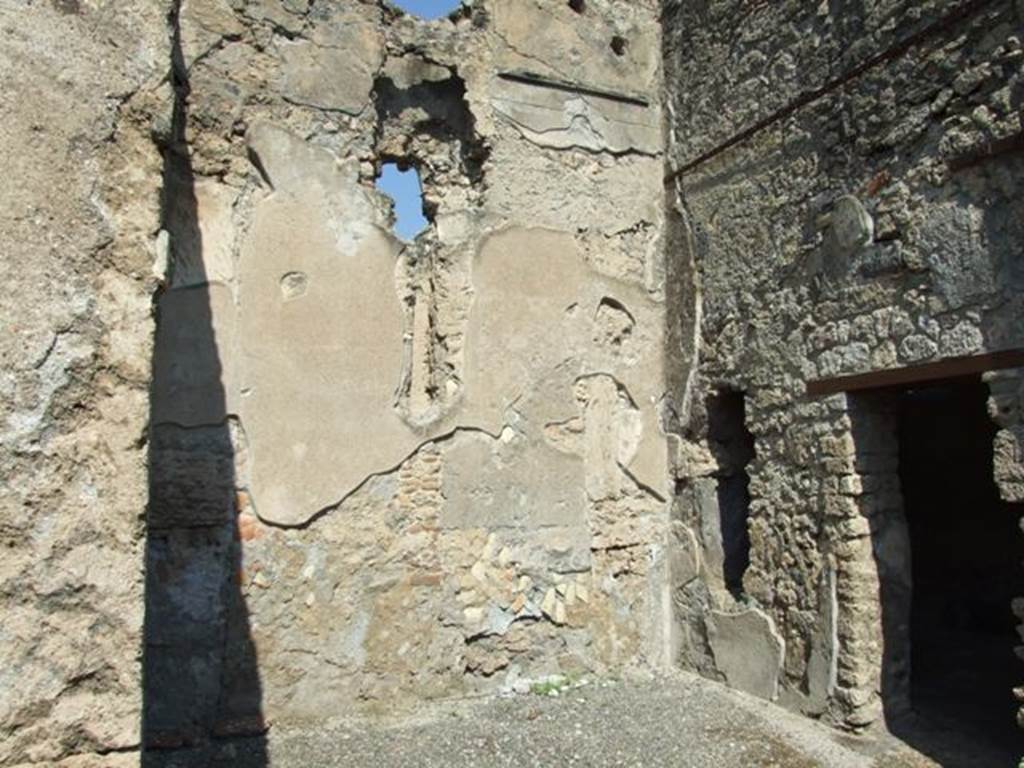 I.10.8 Pompeii. March 2009. Room 2, oecus, in north-east corner of atrium, with doorway to room 3.
This spacious square room had a barrel-vaulted ceiling with a floor of fine cocciopesto, consisting of a dense lattice of white tesserae, adorned in the center by a square with a motif of meander and in front, by the threshold/sill, with a diamond chessboard design.
The walls were simply covered in white plaster, and high up on the north wall were traces of an earlier decoration in the 1st Style.
See Notizie degli Scavi, 1934, (p.309).
