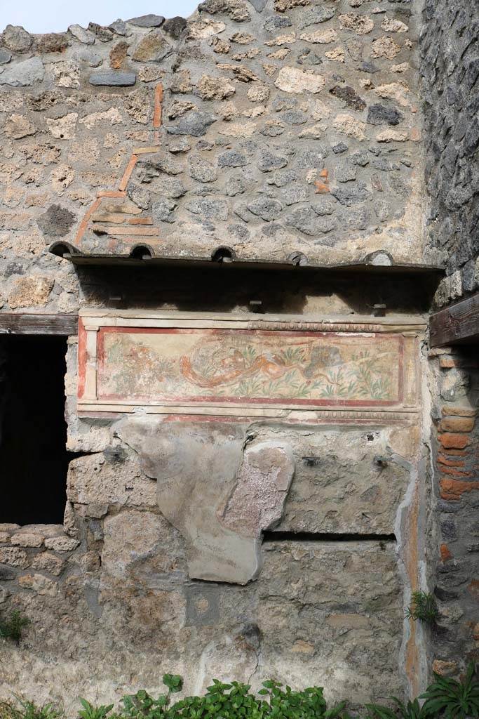 I.11.11 Pompeii. December 2018.
Looking towards painted lararium on east end of north wall of bar-room. Photo courtesy of Aude Durand.