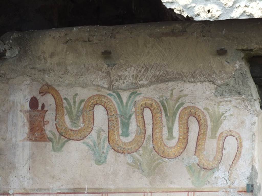 I.11.11 Pompeii. March 2009. Lararium. A serpent approaching a round altar from the left, passing through perennial plants.
