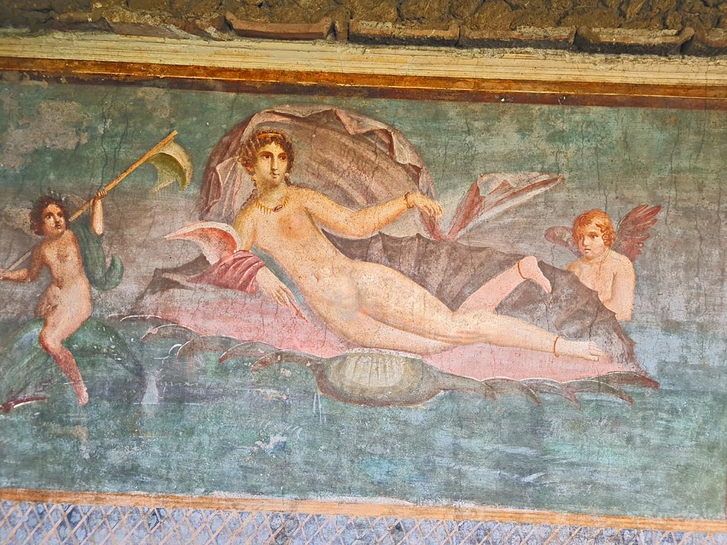 II.3.3 Pompeii. March 2024.
Room 11, central panel from south wall with Venus/Aphrodite in a shell. One cupid rides on a dolphin, the other is supporting the shell.
Photo courtesy of Giuseppe Ciaramella.