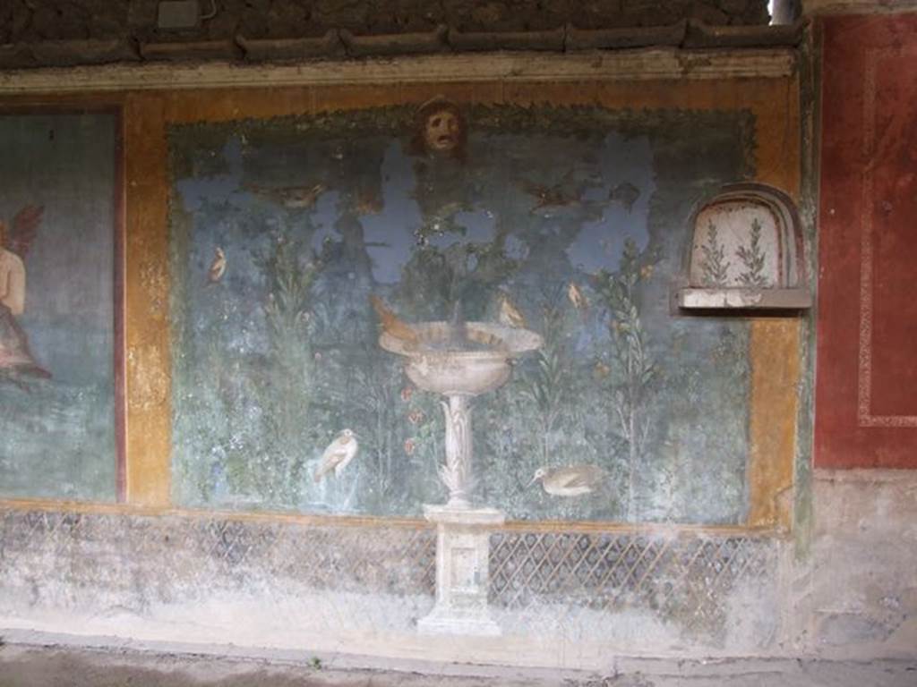 II.3.3 Pompeii. December 2005.Room 11, west panel of south wall of peristyle. Wall painting of fountain with garden, mask and birds.