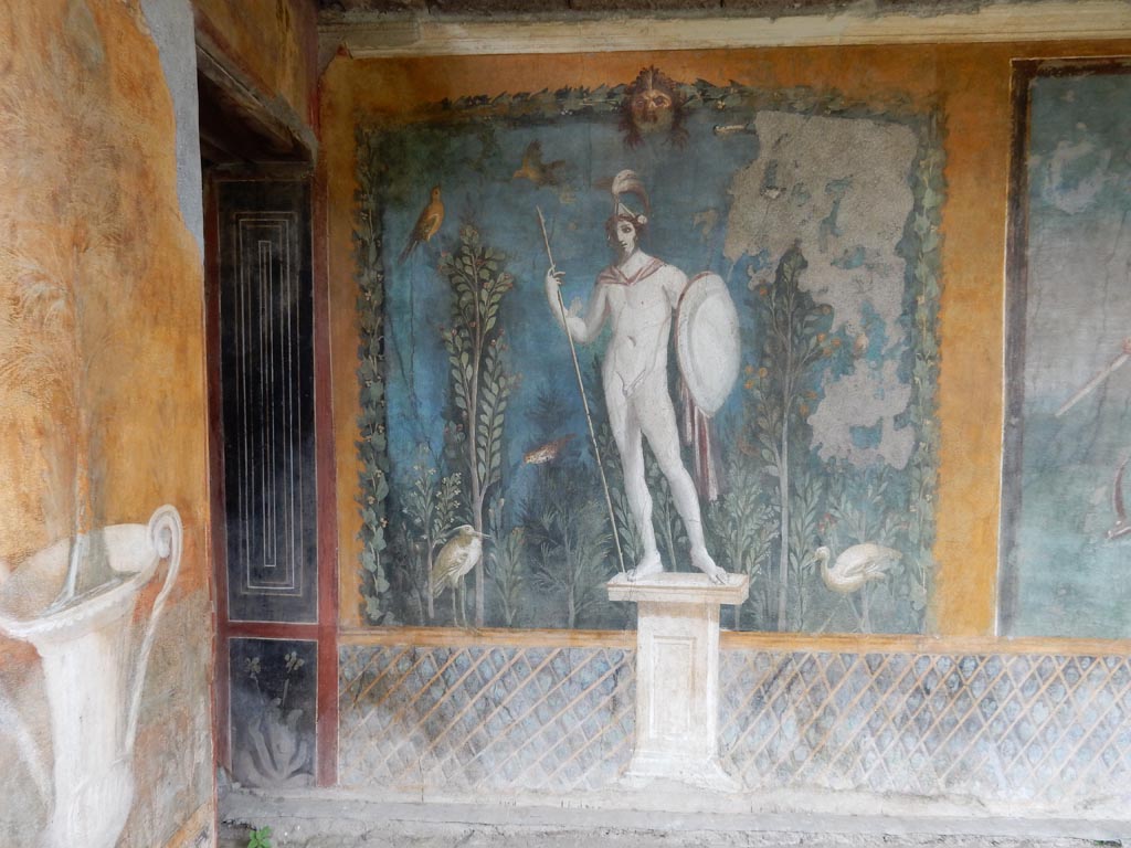 II.3.3 Pompeii. May 2016. Room 11, east panel on south wall of peristyle.
Wall painting of statue of naked Ares / Mars with a lance and shield. Photo courtesy of Buzz Ferebee.