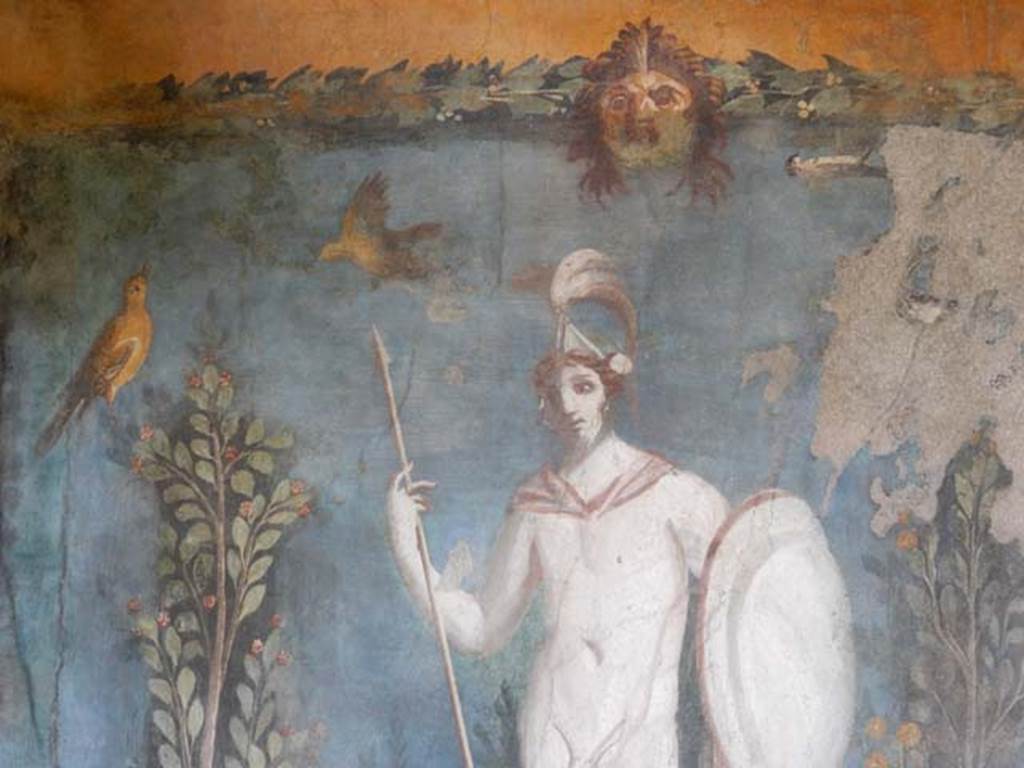 II.3.3 Pompeii. May 2016. Room 11, east panel on south wall of peristyle.
Detail from wall painting of statue of naked Ares / Mars with a lance and shield, birds and mask. Photo courtesy of Buzz Ferebee.