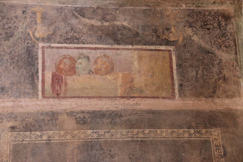 II.3.3 Pompeii. September 2017. Room 6, detail of painted panel with masks from upper south wall.
Photo courtesy of Klaus Heese.