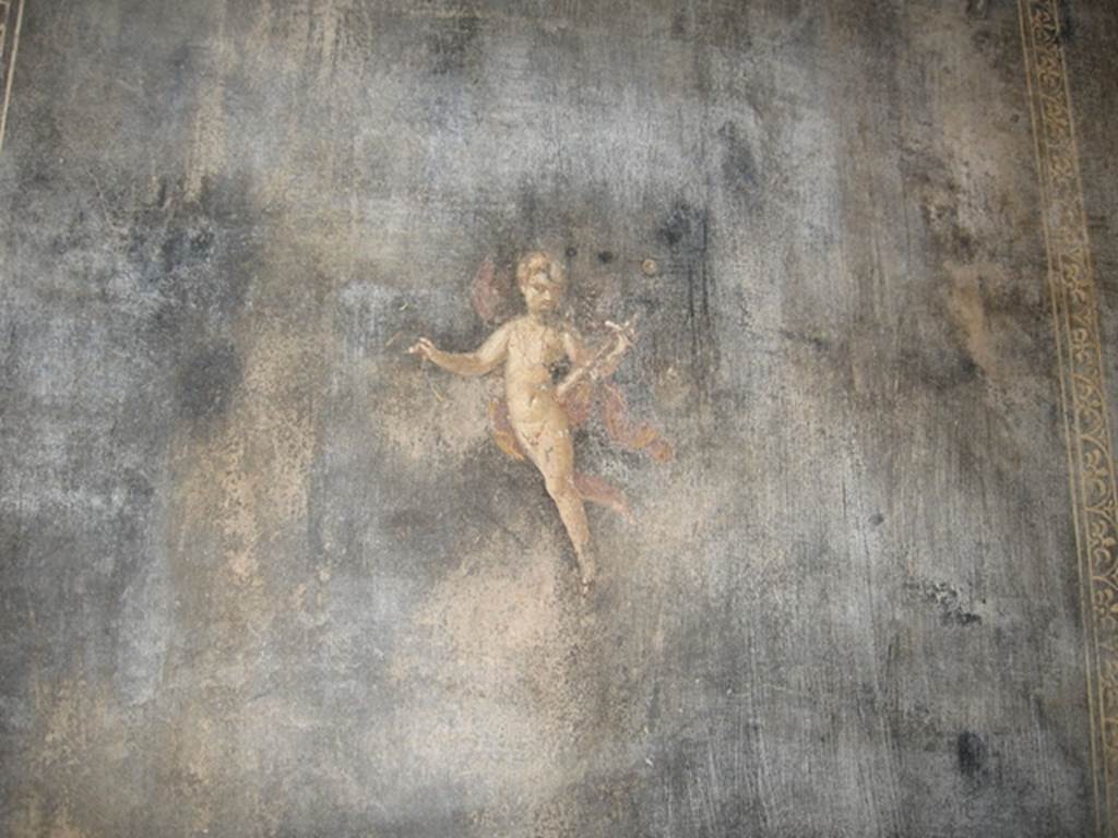 II.3.3 Pompeii. July 2007. Room 6, south wall of triclinium.
Wall painting of Amorino or flying cupid with a baetylus (or alabaster vase) in his left hand.
Photograph courtesy of Kathryn Breen.
