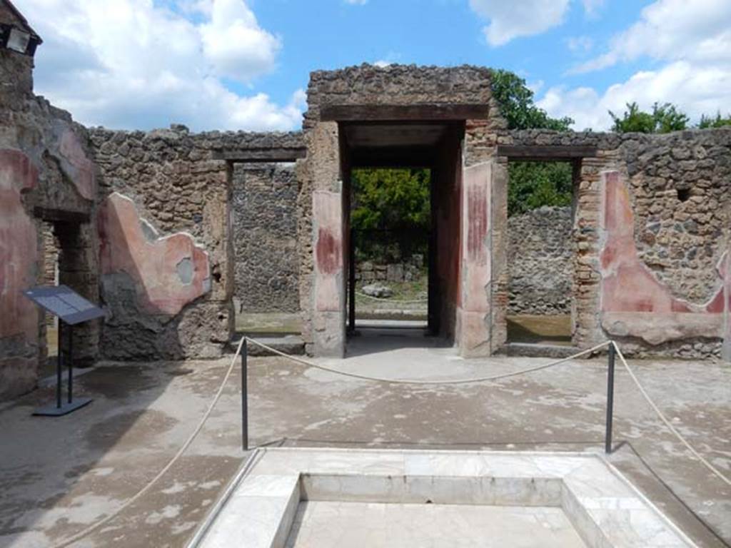 II.3.3 Pompeii. May 2016. Looking north across impluvium in atrium. The doorway to room 7 can be seen, centre left. Photo courtesy of Buzz Ferebee.