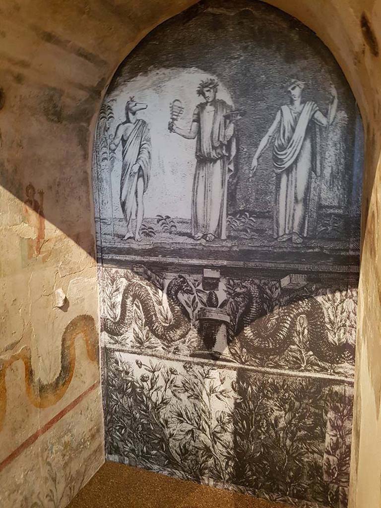 II.4.6 Pompeii. June 2016. Reconstruction of niche from sacrarium, looking towards rear.
According to Boyce’s description, Piranesi's print (here shown on the rear wall) is inaccurate in that Isis should be seated upon a throne but is standing in the centre.
See Boyce G. K., 1937. Corpus of the Lararia of Pompeii. Rome: MAAR 14. (p.95, no.471)
Photograph © Parco Archeologico di Pompei.