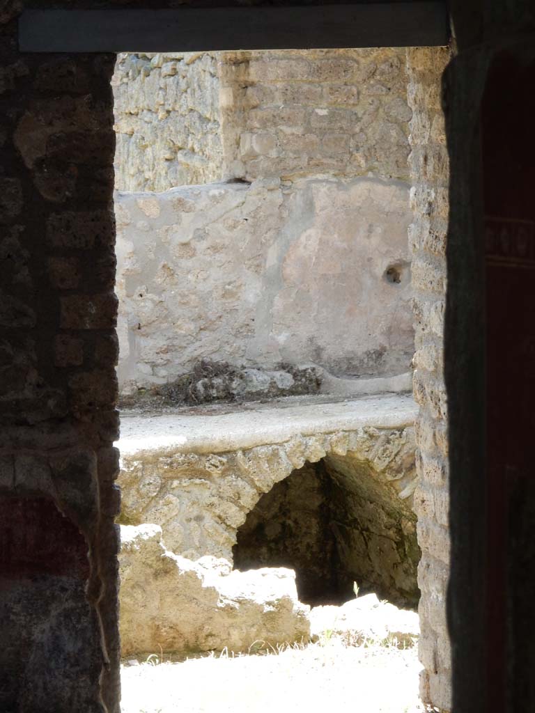 II.4.10 Pompeii. June 2019. Detail of hearth through kitchen doorway from atrium.
Photo courtesy of Buzz Ferebee.