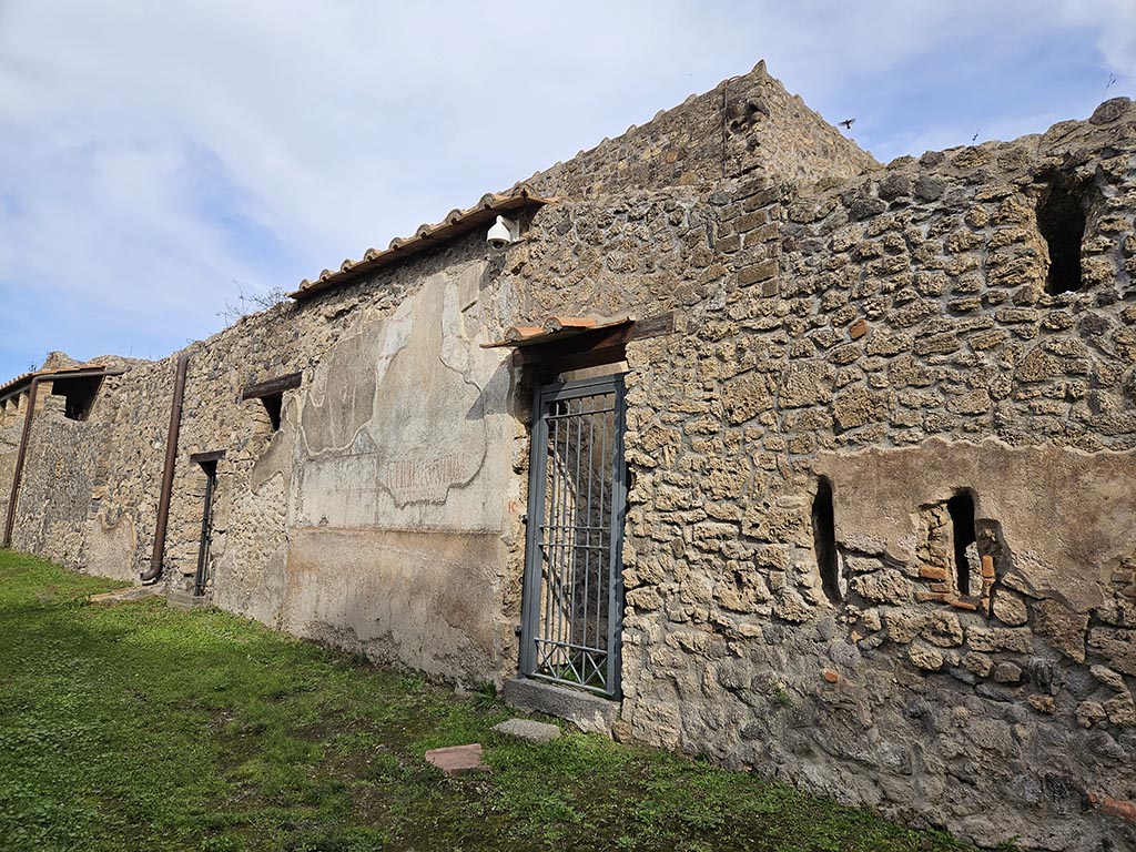 II.4.10 Pompeii. November 2024.
Looking north along east side of Vicolo di Giulia Felice, and entrance doorway. Photo courtesy of Annette Haug.