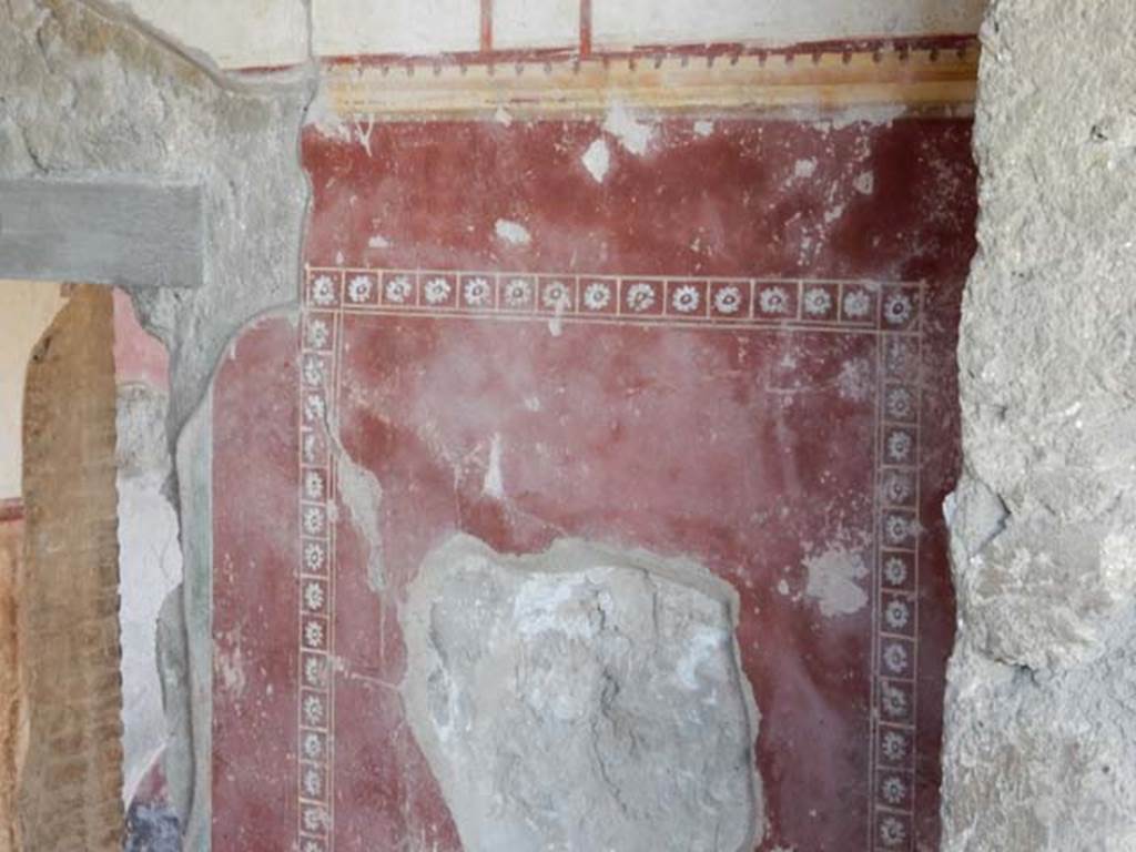 II.4.10 Pompeii. May 2016. Detail of painted decoration on west wall of steps from west portico. Photo courtesy of Buzz Ferebee.