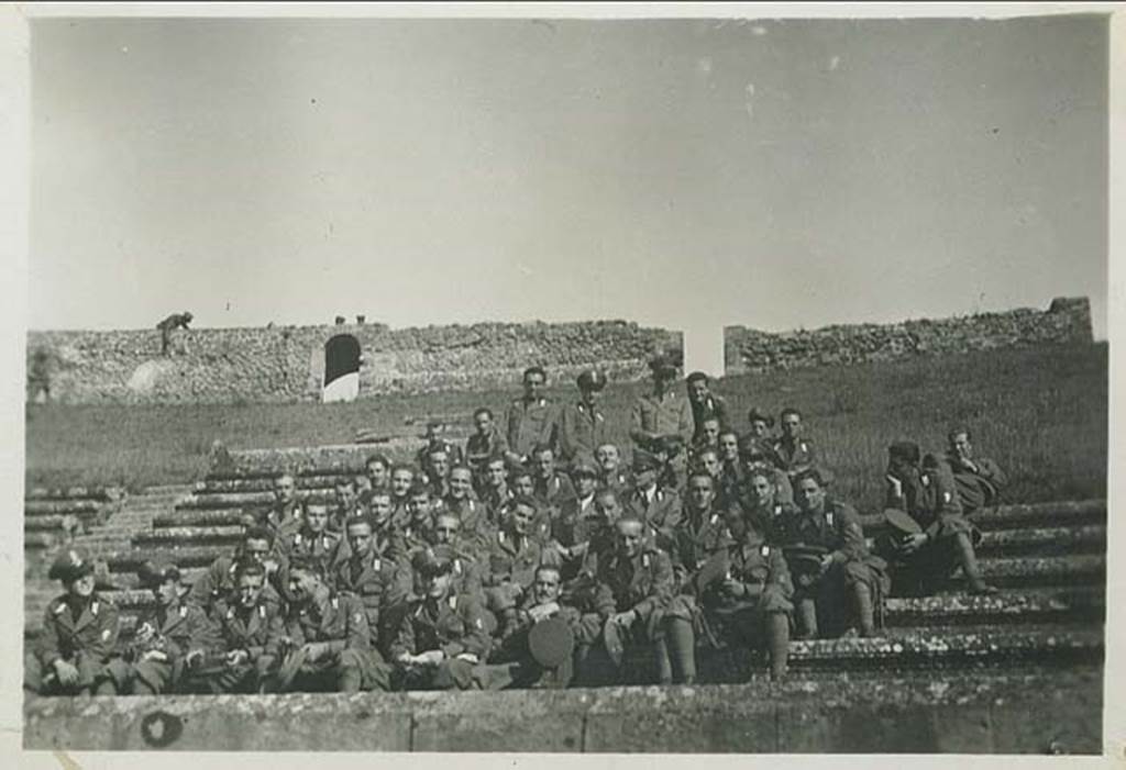II.6 Pompeii. 26th October 1936. Italian soldiers sitting as a group in the amphitheatre.
Photo courtesy of Rick Bauer.