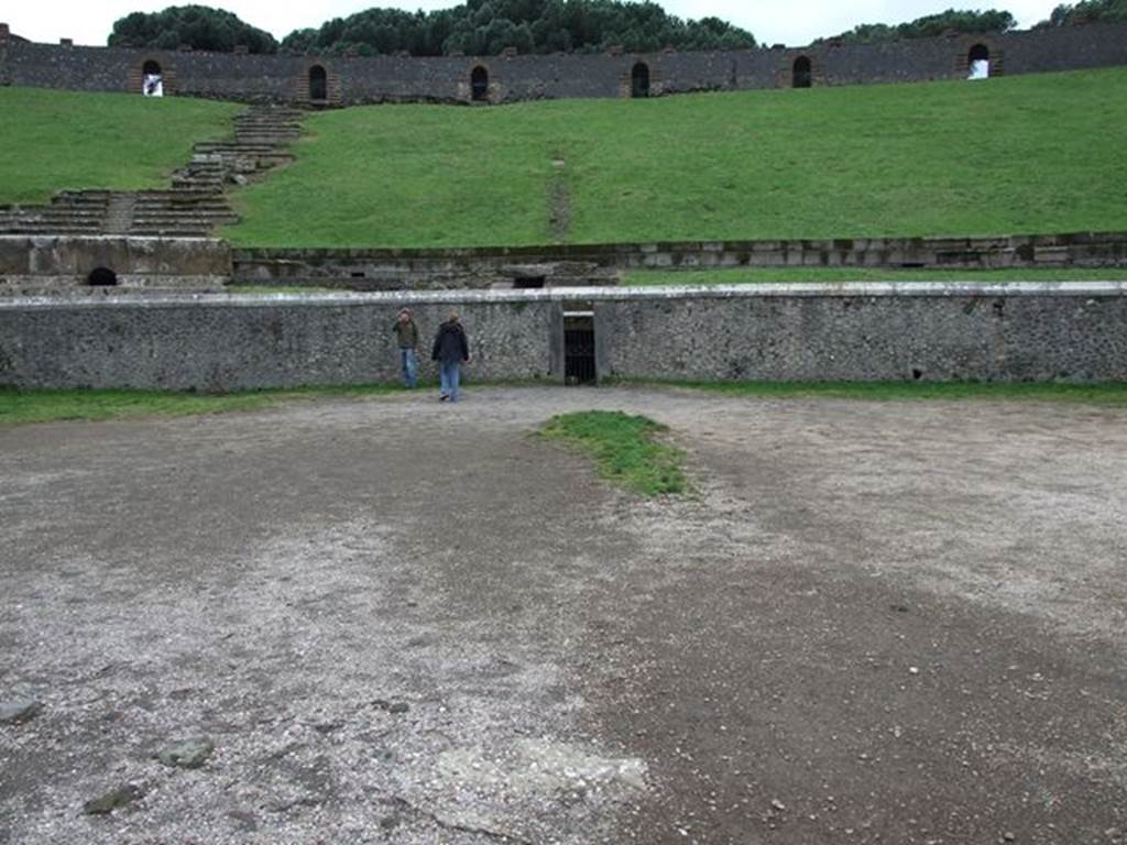 II.6 Pompeii. December 2006. Arena and seating, west side. Showing doorway to tunnel leading from arena floor to outside the Amphitheatre.
