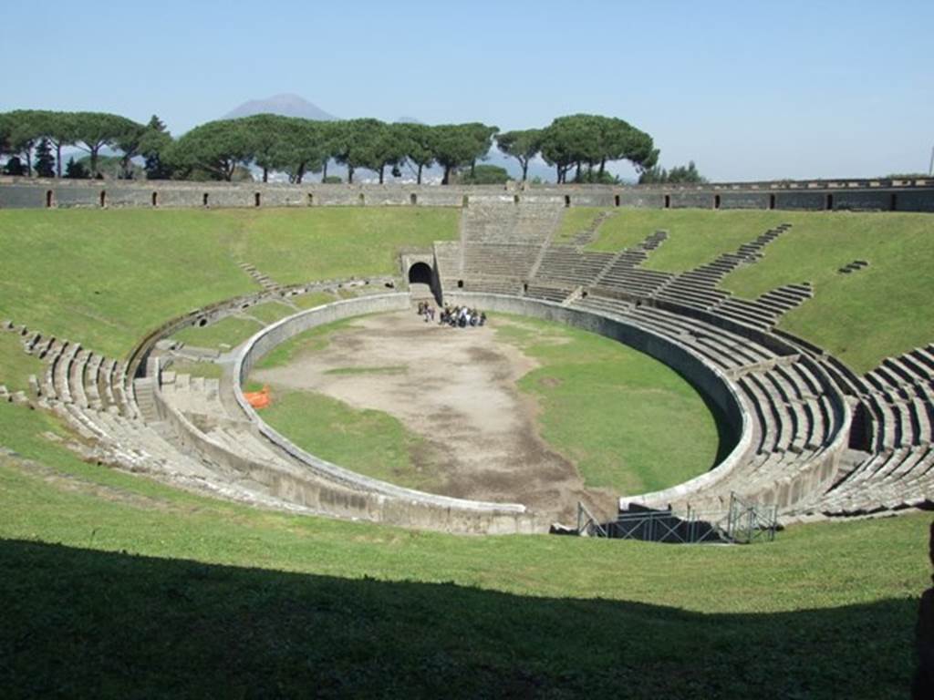 II.6 Pompeii. March 2009. Looking across the arena of the Amphitheatre. Looking north through the vomitoria (passageway leading from the terrace to the upper seating)