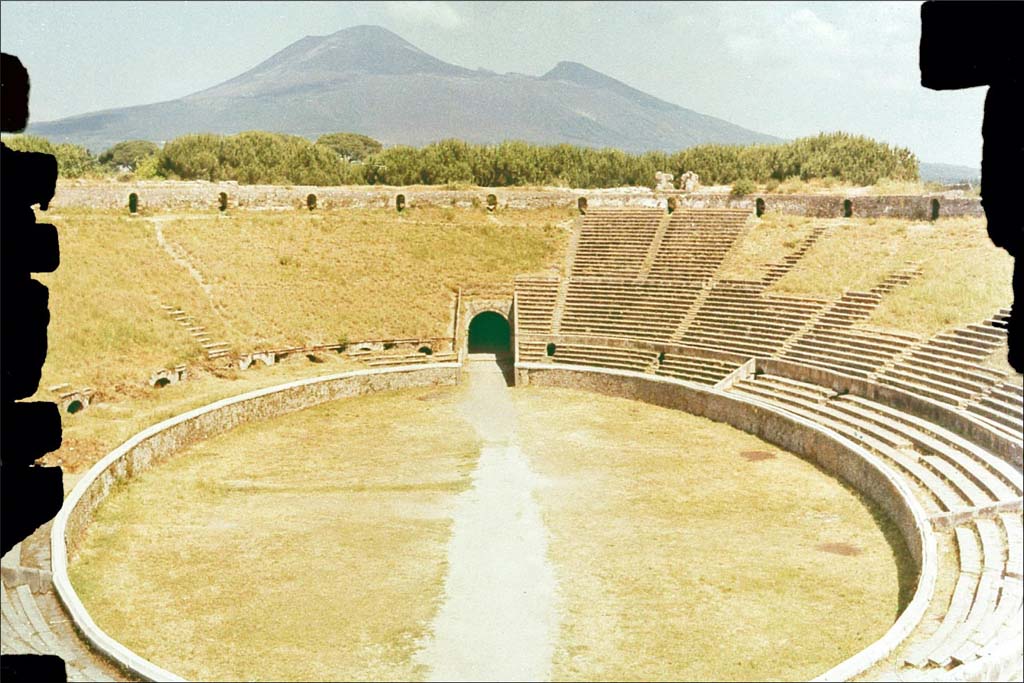 II.6 Pompeii. June 1962. Looking north across amphitheatre towards Vesuvius.
Photo by Brian Philp: Pictorial Colour Slides, forwarded by Peter Woods
(P43.7 Arena and Tiers Ampitheatre.