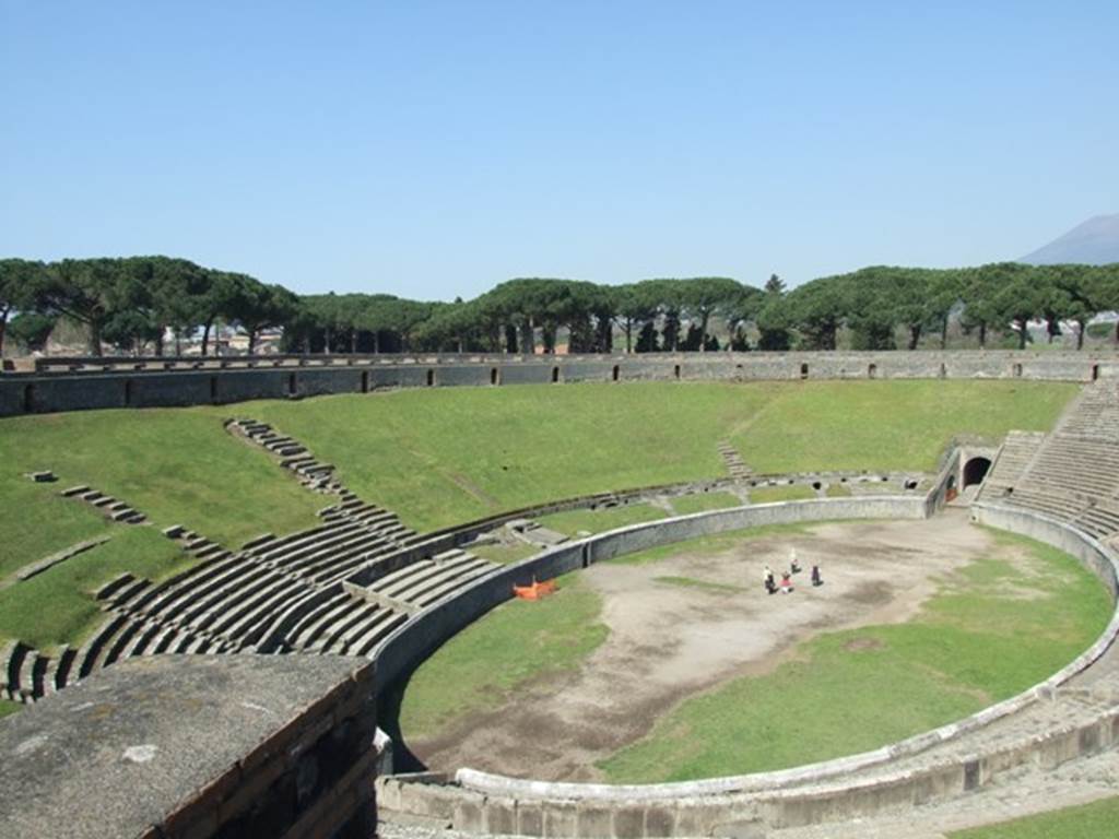 II.6 Pompeii. March 2009. Looking north-west from upper level of the Amphitheatre. In the night raid of 20th September 1943, one bomb fell onto the arena, and another towards the north side. This caused the demolition of part of the enclosing wall of the arena, and a section of seats of the ima cavea on the north-west side. See Garcia y Garcia, L., 2006. Danni di guerra a Pompei. Rome: L’Erma di Bretschneider. (p.46)