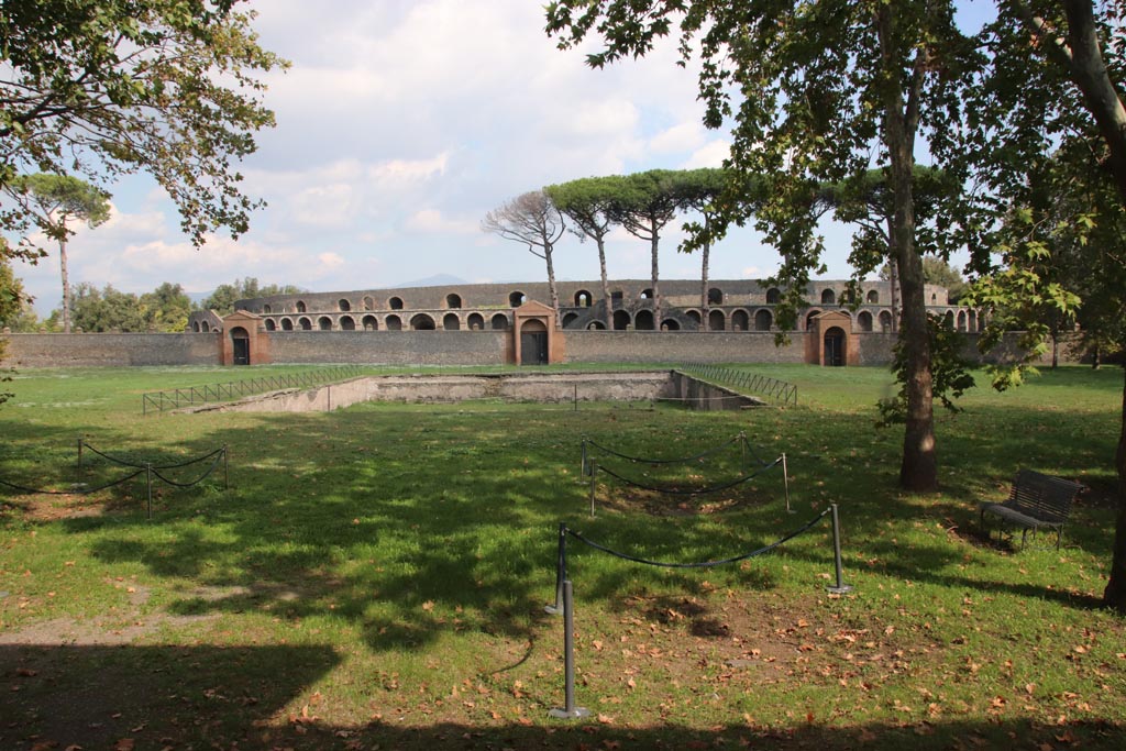 II.7.3, in centre, Pompeii. October 2022. Looking east across pool in palestra towards Amphitheatre. Photo courtesy of Klaus Heese