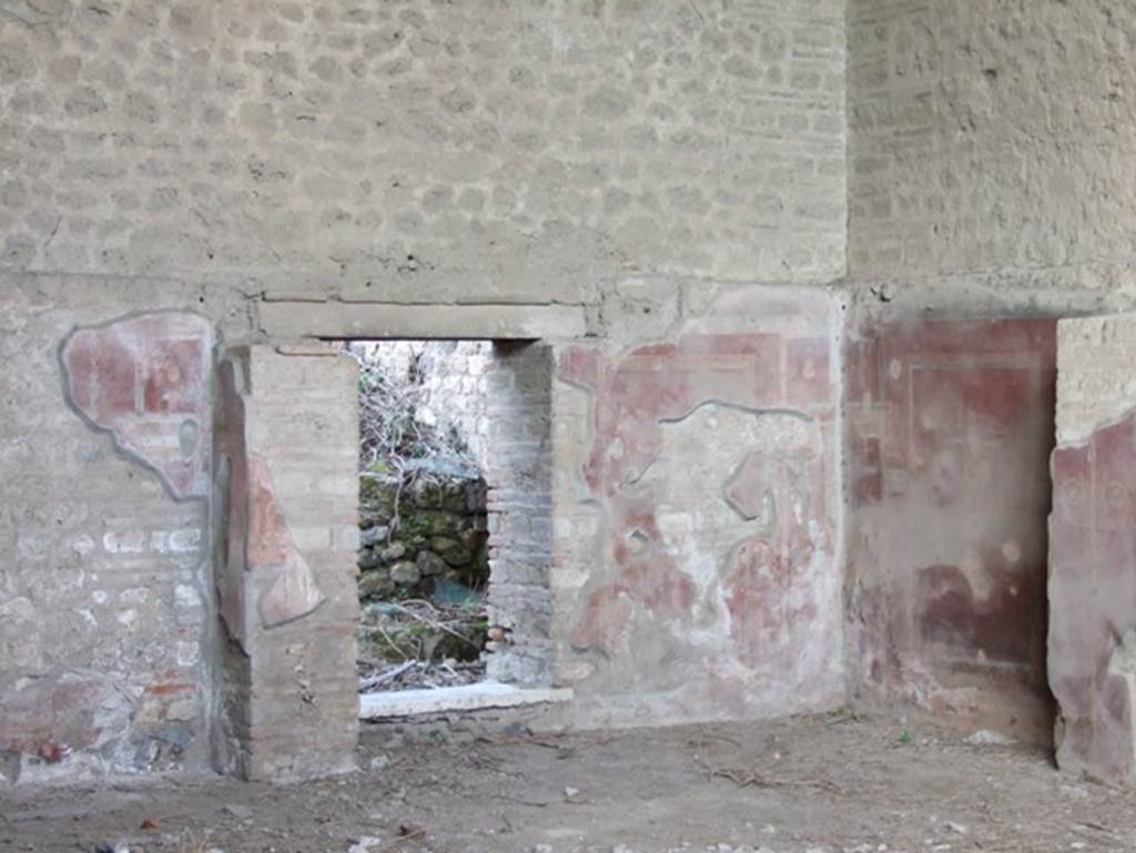 III.3.6 Pompeii. Schola Armaturarum Iuventutis Pompeianae. December 2007. Brick pillars and painted plaster and door to rear rooms on east end of North wall.