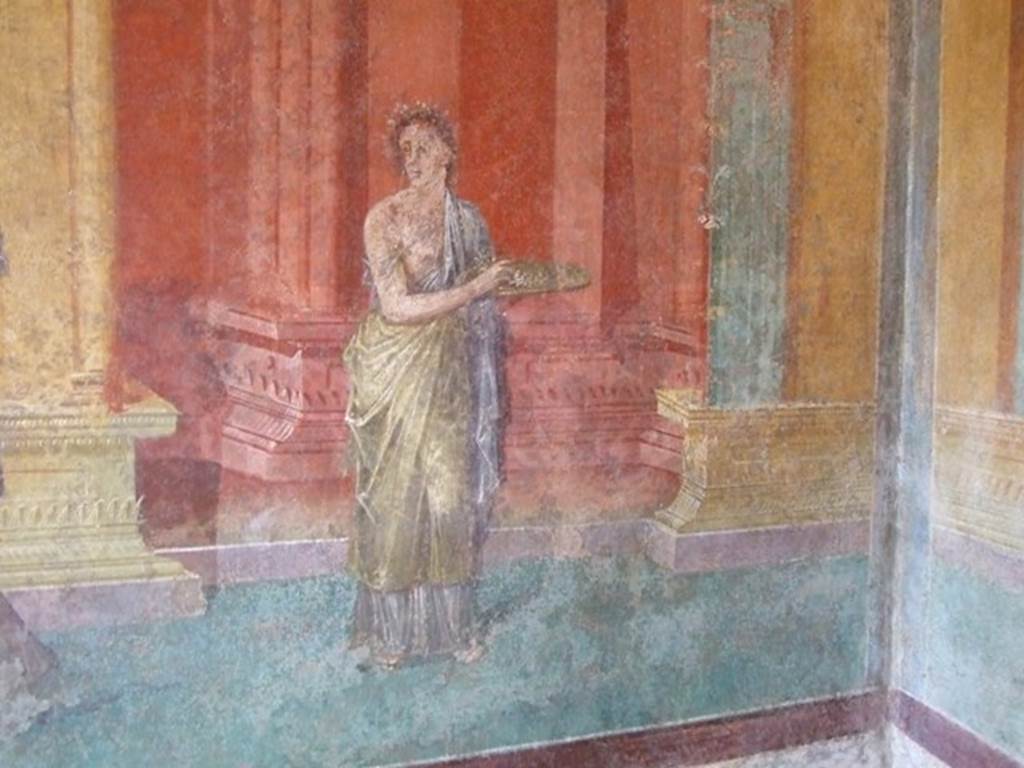 III.4.b Pompeii. March 2009. Room 3, west wall of oecus. Detail of wall painting of female figure carrying a plate.
