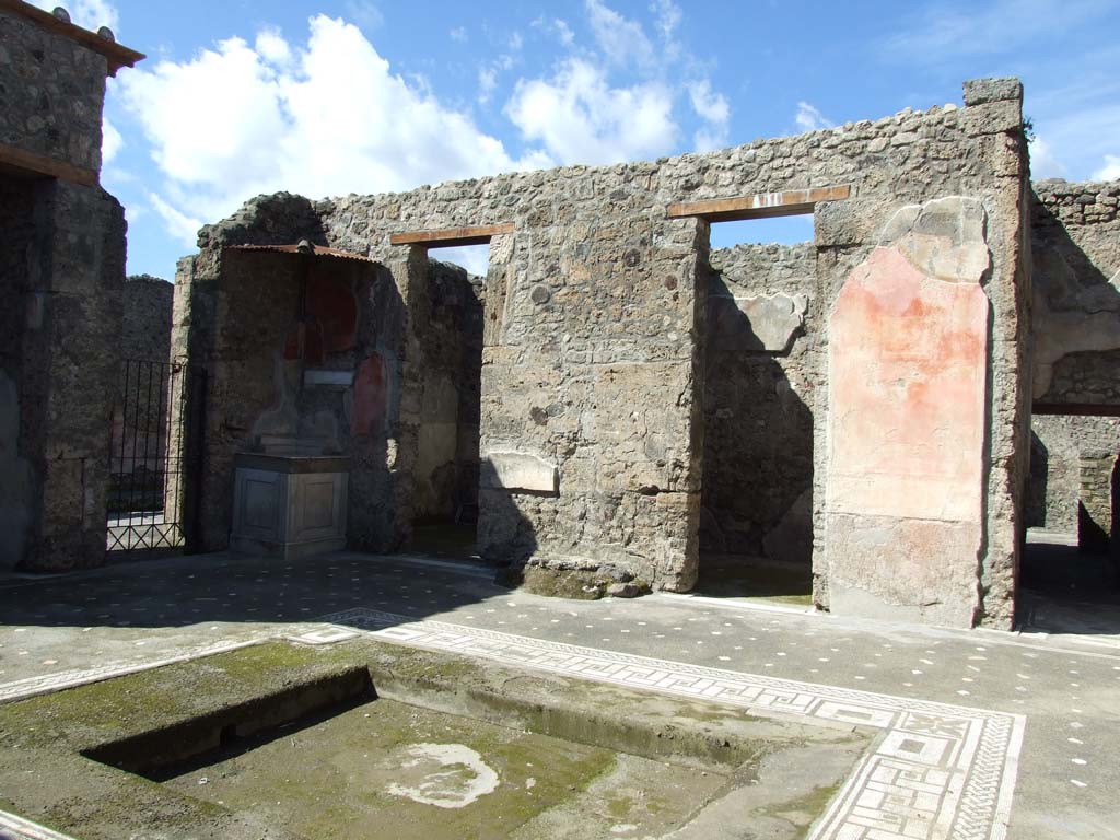 V.1.26 Pompeii. March 2009. Room 1, doorway to shop at V.1.25, lararium, two cubicula and ala on north side of atrium.