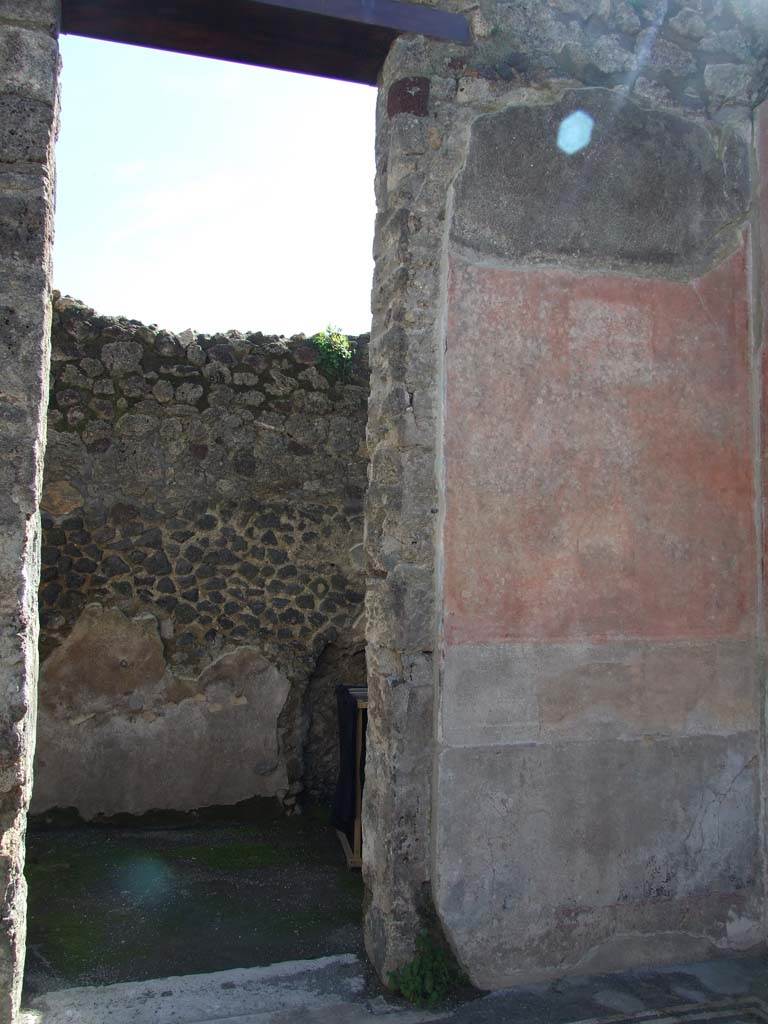 V.1.26 Pompeii. March 2009. Room 7, doorway in south wall of atrium. 
According to Niccolini, on the walls of the atrium in the south-west corner were two paintings.
On the west wall was a painting of Ulysses and Penelope.
On the south wall, above on the right of the doorway, was a theatrical scene.
See Niccolini F, 1890. Le case ed i monumenti di Pompei: Volume Terzo. Napoli. 
