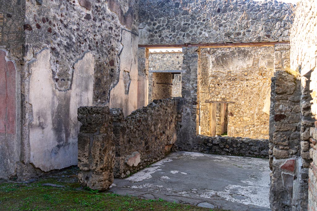 V.1.26 Pompeii. October 2023. Room “k”, corridor to atrium, on left.
Room “m”, centre right, looking west through window into north ala “e”. Photo courtesy of Johannes Eber.