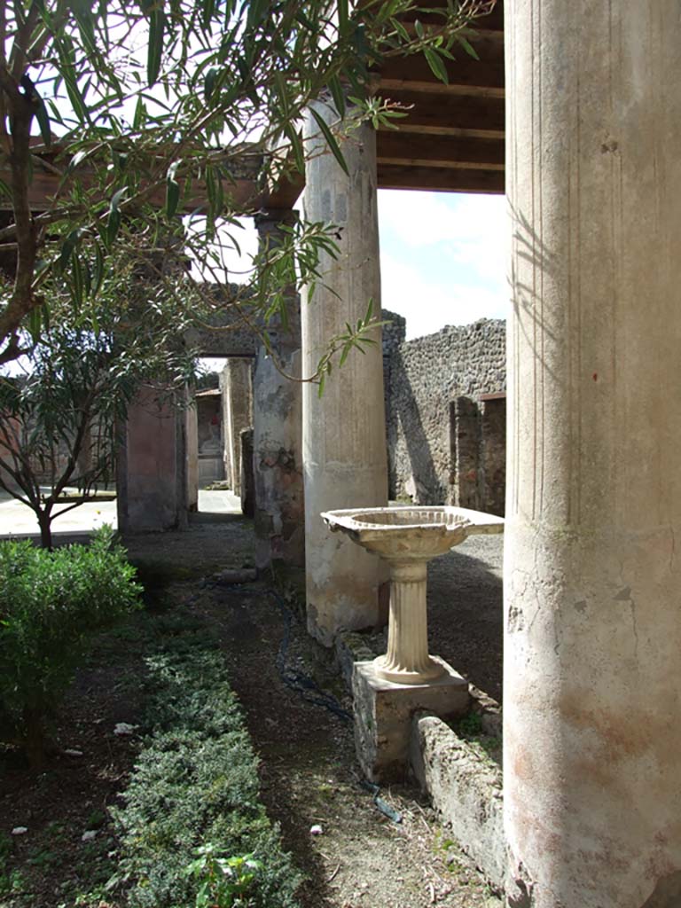 V.1.26 Pompeii. March 2009. Room L, looking west along north side of garden wall, under north portico.