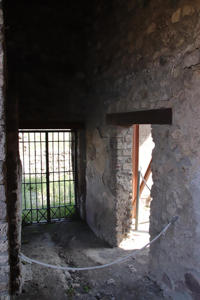 V.4.a Pompeii. October 2023.
Doorway to room ‘v’, on right. Looking east towards rear doorway at V.4.11.
Photo courtesy of Klaus Heese.