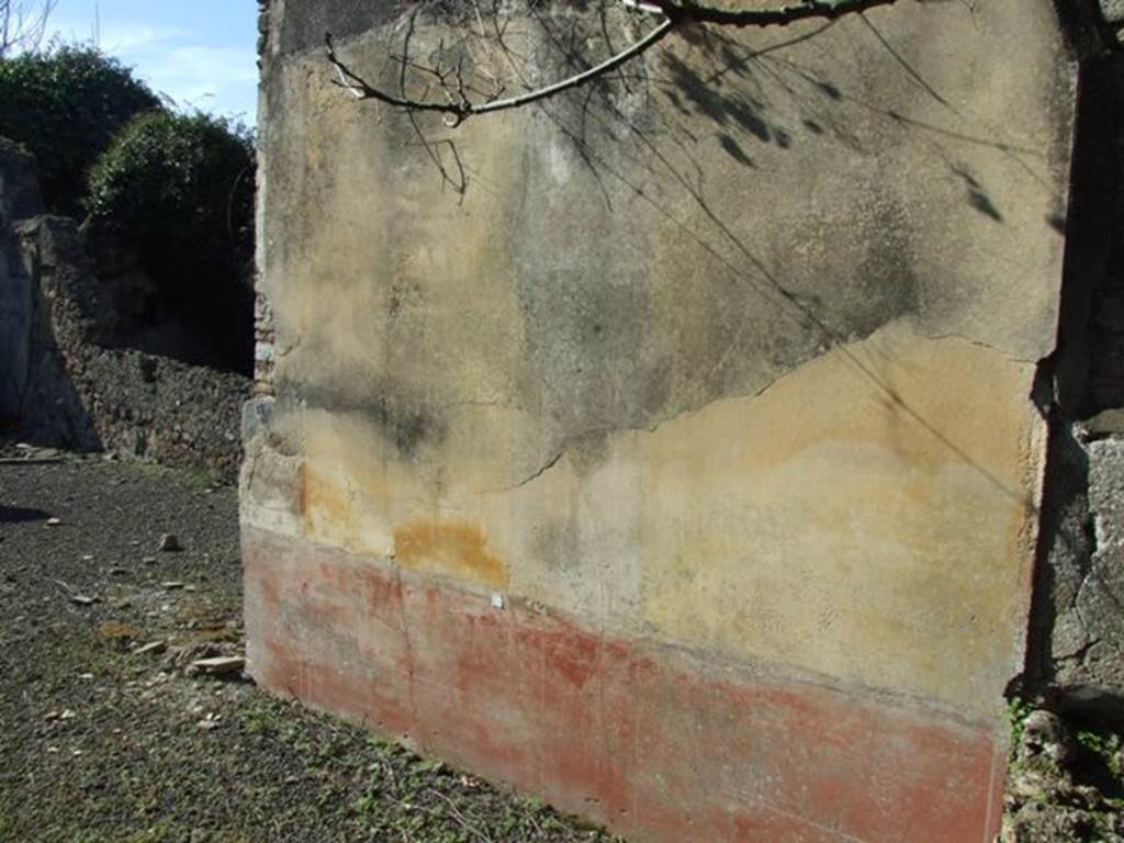 V.4.c Pompeii. March 2009. Room G, north wall of tablinum. According to Sogliano, in tablinum G, the two north and south walls were decorated with big yellow panels. These were separated by architectural paintings on a white background. In the centre of each of the four panels was a painted flying figure of a Season. On the north wall, to the left, was Spring. The figure was poorly preserved when found. In the panel to the right, was Summer, naked except for a broad green veil, holding in the right the sickle and in the other hand, a sheaf. On the south wall, the panel on the left which had showed Autumn was quite faded. On the right was Winter, entirely covered by a vast green blanket which covered the head. The upper part of the above mentioned walls were decorated in white, with arabesques and garlands. The lower part was red. The floor was of opus signinum.
See Notizie degli Scavi, 1905, (p.133).