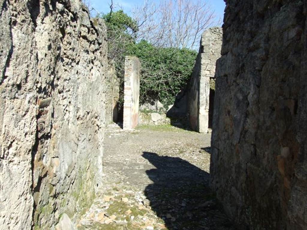 V.4.c Pompeii. March 2009. Looking east across room A, the fauces, towards atrium and tablinum.
According to NdS, (1902) –
In the house in Reg. V that had its doorway opposite to the one at V.3.11 (therefore V.4.c), I verify that on the 1st May, an important discovery was made of 4 skeletons with the following objects –
Large gold bracelet in the shape of facing serpents;
Two gold rings set with stone;
A pair of earrings;
One aureus of Nero, and two of Domitian;
29 silver coins, silver bronze mirror
The death of the unfortunates would have seemed to have been from the fire that caused the floor of the upper room, where they had taken refuge, to collapse, and whose violence had partly burnt their bones and left traces on the paintings on the walls.
The house, to judge from the part excavated up until now, will not have been very large, nor as beautiful as the one opposite to it (V.3.11).
However, it had in the tablinum fairly good paintings showing the four seasons (Autumn completely disappeared, and in the atrium was a painting of Mercury with purse and staff/caduceus, very similar to the one existing in the thermopolium V.4.6-7 (see Notizie1899, p. 343) however, “ours” had a large serpent curled/tangled at his feet.
R.PARIBENI.
See Notizie degli Scavi, 1902, (p.276).