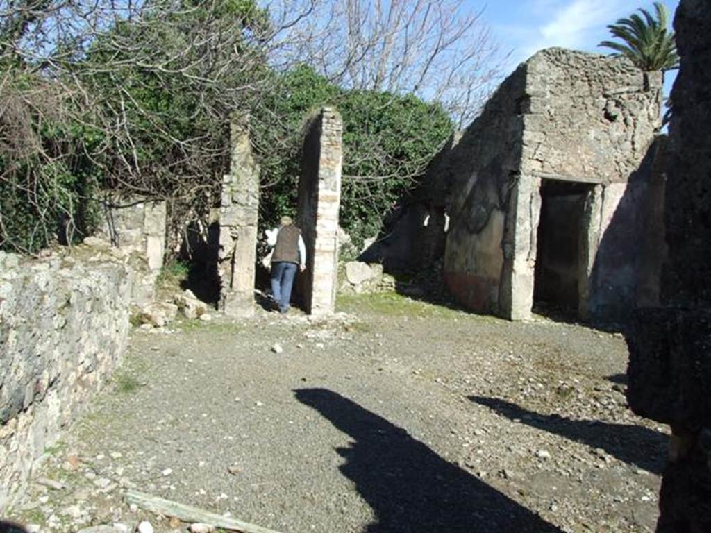 V.4.c Pompeii. March 2009. Looking east across north side of atrium, room B. On the right of the photo, on the south side of the doorway of room H, a painting of Mercury was found in a large red panel. He was turned slightly to the right, standing, leaning on his right leg and hip, naked except for a long pink cloak, and helmet. His boots were almost faded but without doubt were winged. In his left he held the staff against his corresponding shoulder, and with his right hand he held the purse. On the ground at his feet, was the omphalos with the serpent around it. See Notizie degli Scavi, 1905, p.131.