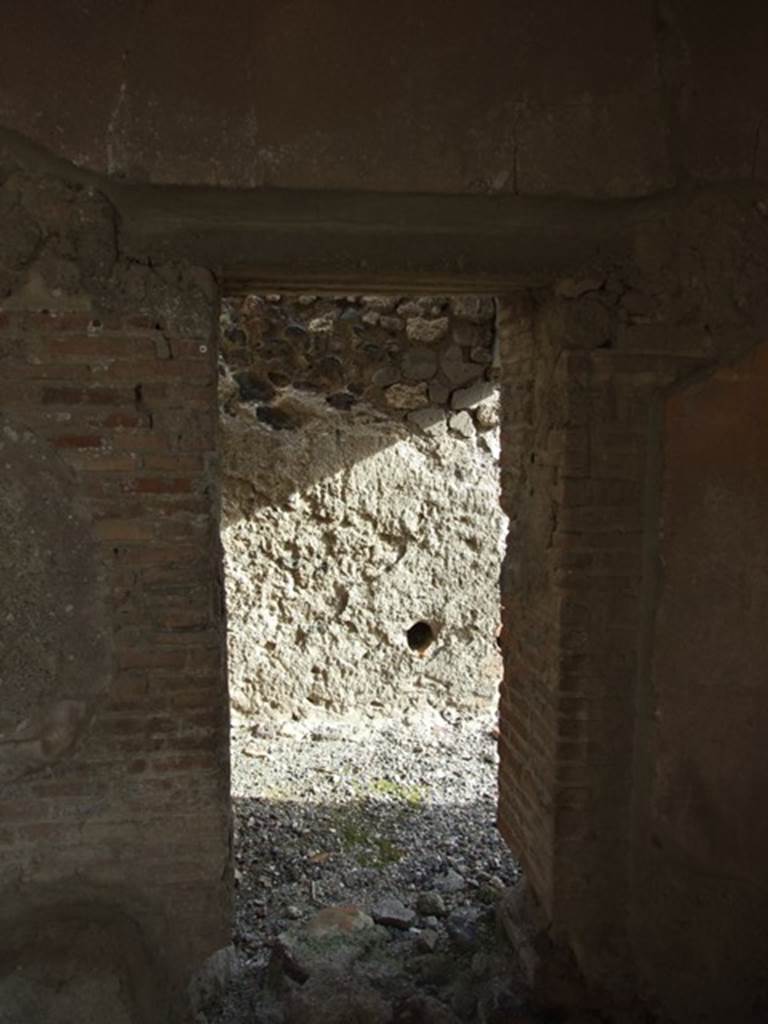VI.1.7 Pompeii. December 2007.
Doorway to room 24, services’ room for the baths area, in south-east corner of portico.
In the east wall, one of the two conduits acting as vents from the adjacent praefurnium can be seen.