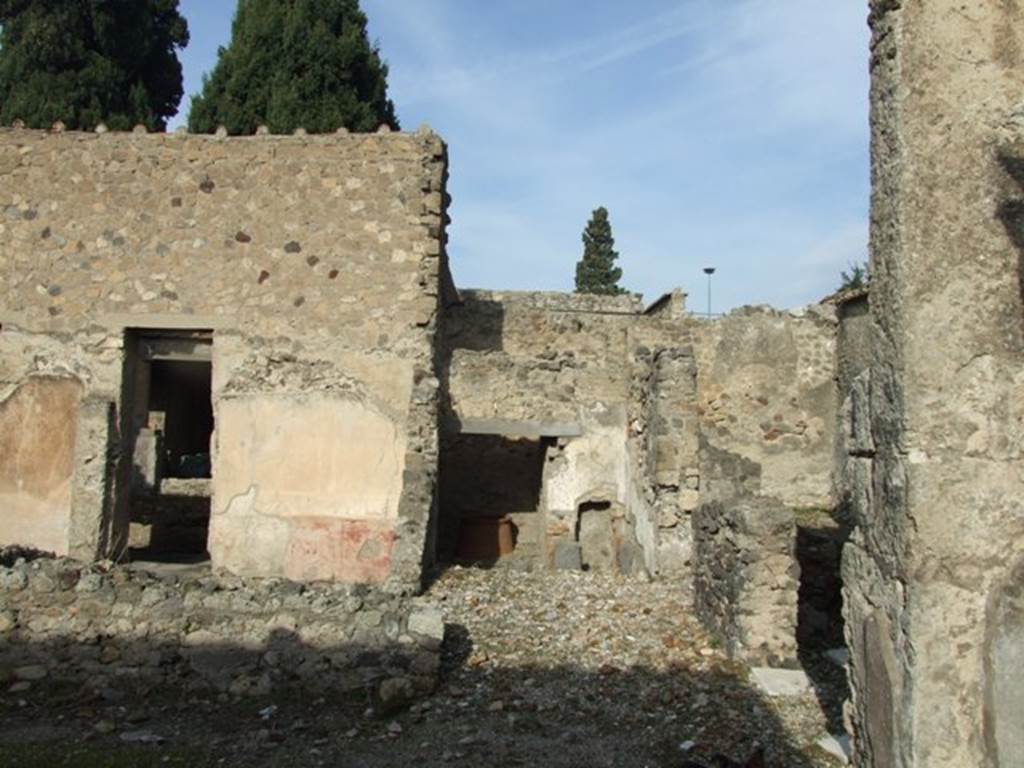 VI.1.7 Pompeii. December 2007. Looking north from outside room 27.
Doorway in room 12 to peristyle, on left. Room 28 centre with room 24 at rear, and doorway entrance of room 27, on right. Rooms 24-28 would have been the bath suite. According to Robinson and Jones, a bath suite was constructed on the north-east side of the atrium. There was an entrance, hot and warm rooms, a hot plunge pool, a wash room, and, in the middle of the large peristyle, an open-air swimming pool.
See article called Imperial Pompeii, a city of extremes? in Current World Archaeology, Number 4, March/April 2004, p.32-39.