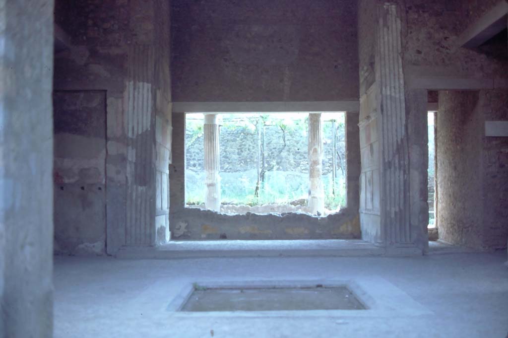 VI.2.4 Pompeii, 8th August 1976. Looking east across atrium and impluvium towards tablinum.
Photo courtesy of Rick Bauer, from Dr George Fay’s slides collection.

