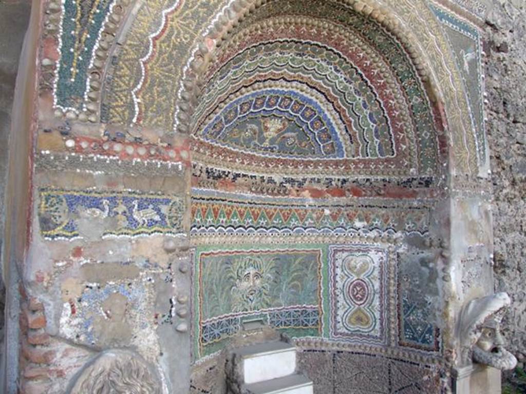 VI.8.22 Pompeii. March 2009. Detail of fountain, with centre panel of a mask of a river god surrounded by plants.