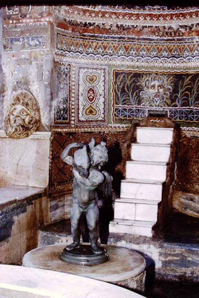 VI.8.22 Pompeii, 1978. Detail of mosaic on fountain, and bronze statuette. Photo by Stanley A. Jashemski.
Source: The Wilhelmina and Stanley A. Jashemski archive in the University of Maryland Library, Special Collections (See collection page) and made available under the Creative Commons Attribution-Non Commercial License v.4. See Licence and use details. J78f0035
According to Wilhelmina, this bronze statuette is a replica of one found in the garden of IX.7.20, and displayed here. It was one of the finest found in the Vesuvian area.
See Jashemski, W. F., 1993. The Gardens of Pompeii, Volume II: Appendices. New York: Caratzas. (p.135 and p.240)